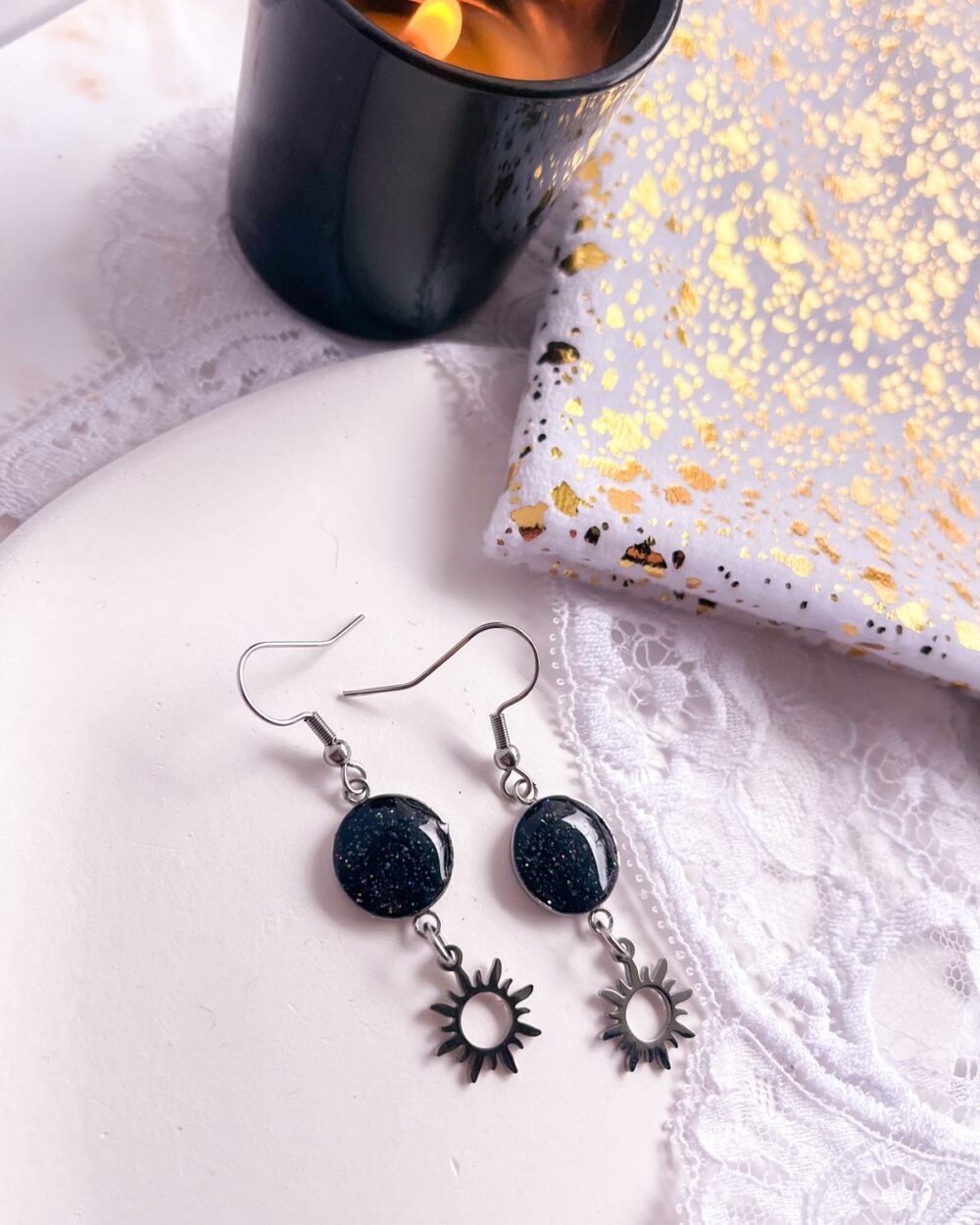 Boucles argentées en acier inoxydable avec médaillon noir de 10 mm incrusté de sable de citrine et breloque soleil pendante.